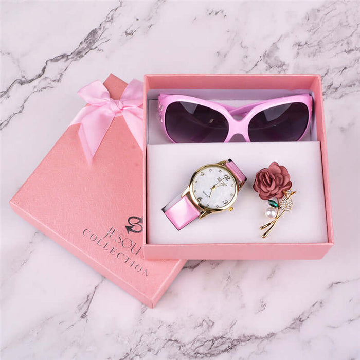 3-Piece Women's Quartz Watch & Sunglasses Gift Box Set in a pink gift box with sunglasses, watch, and floral accessory.