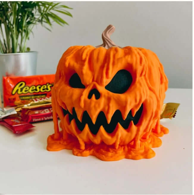 Halloween Melting Pumpkin Candy Bowl With Lid featuring a spooky design and candy in the background.