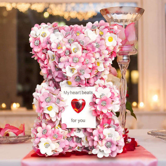 Artificial rose bear made of pink flowers, featuring a heart card that says 'My heart beats for you', perfect for Valentine's gifts.