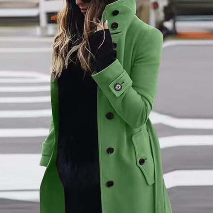 Woman wearing a green autumn winter woolen coat slim fit stand collar jacket on a city street.