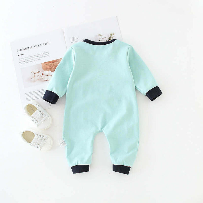 Baby One-Piece Romper Cotton Long Sleeve Diagonal Button Suit in mint color on a white background with shoes and magazines.