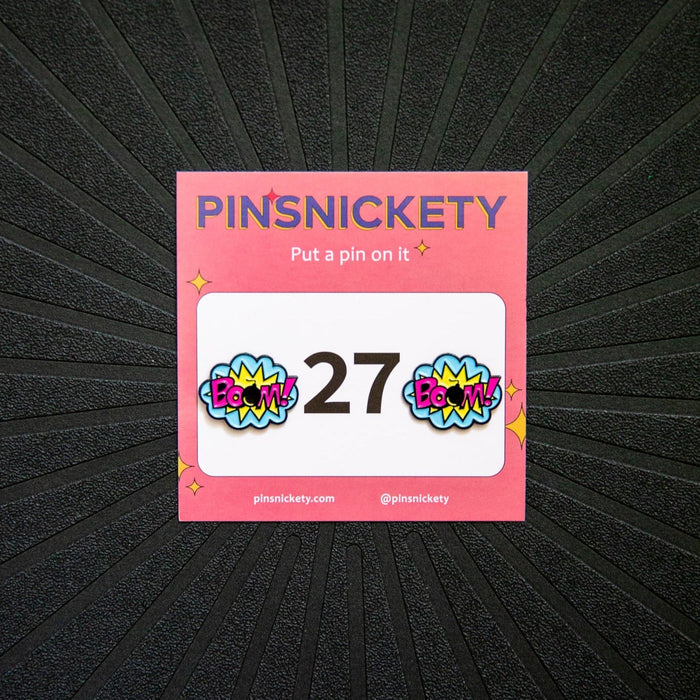 Pinsnickety BOOM! horse show number pins on a saddle pad.