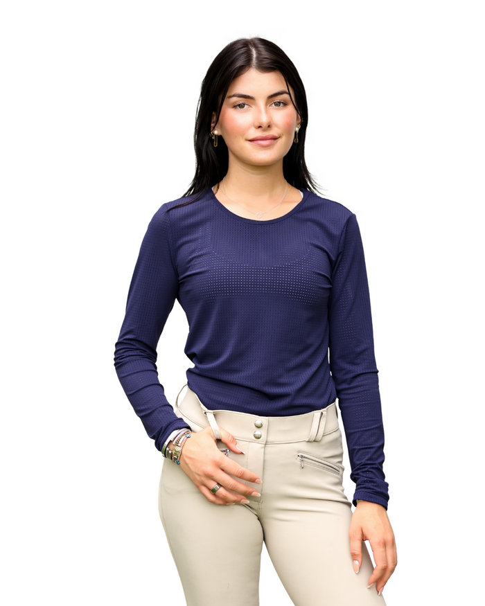 Woman wearing a blue long-sleeve top and beige pants on a white background
