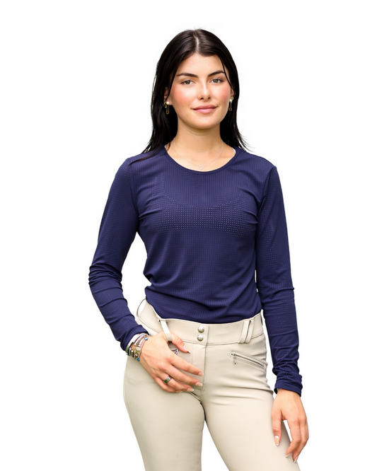 Woman wearing a blue long-sleeve top and beige pants on a white background
