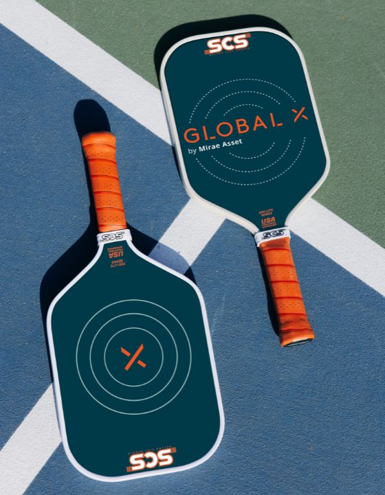Two branded pickleball paddles with the GlobalX logo with orange handles on a blue and green court surface.