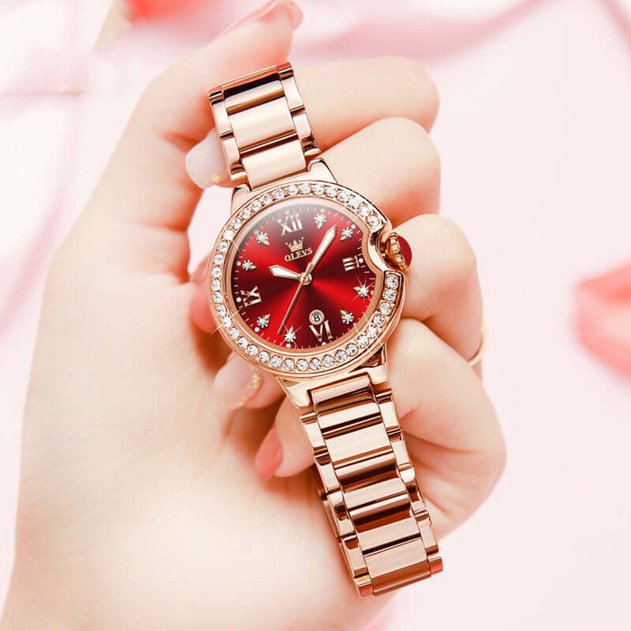 Elegant Waterproof Women Rose Gold Luxury Watch held in hand with a red dial and diamond accents.