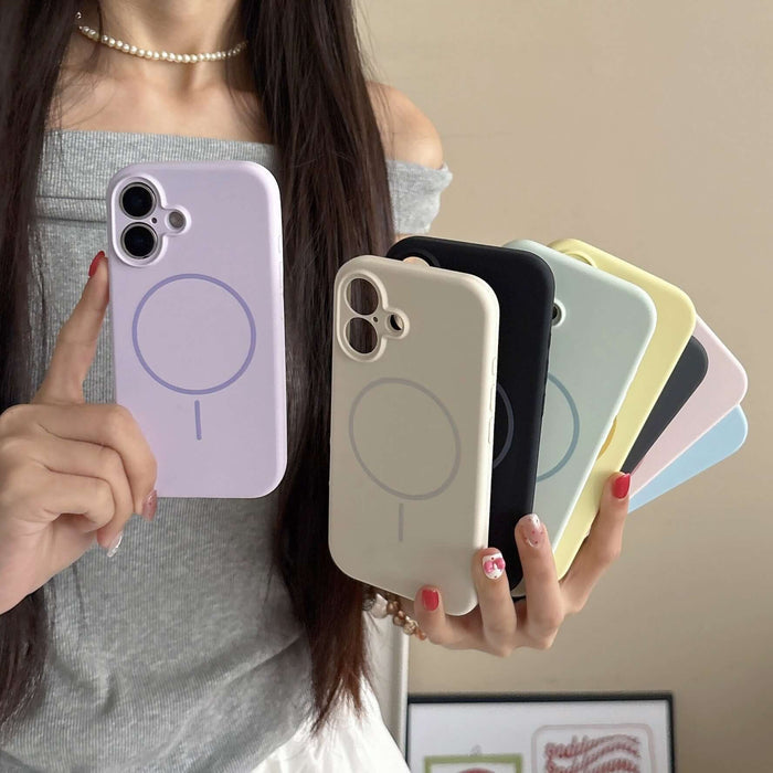 Person holding multiple Fine Circle Magnetic Liquid Silicone Phone Cases in various colors.