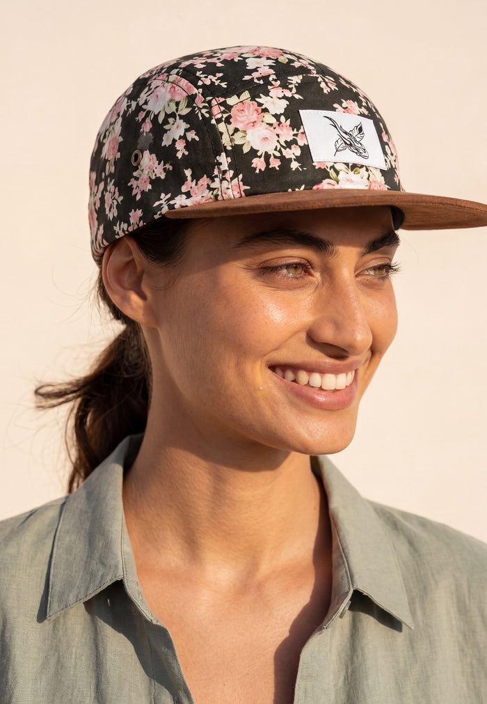 Woman wearing a floral cap with a neutral background