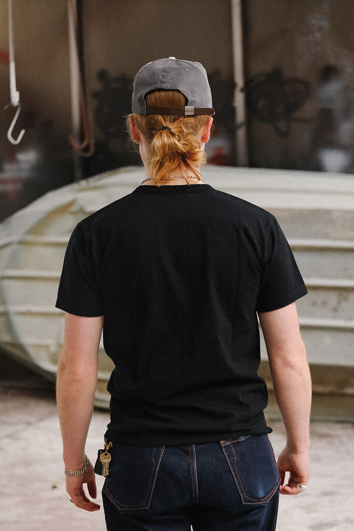Man wearing black t-shirt on blurred background