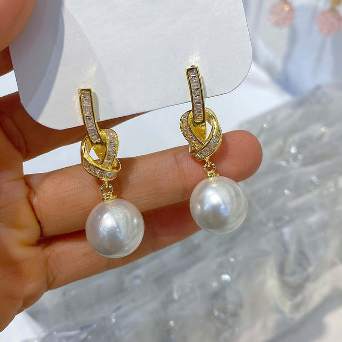 Light Luxury Micro Inlaid Zircon Bow Chain Earrings twist and diamond elements.
