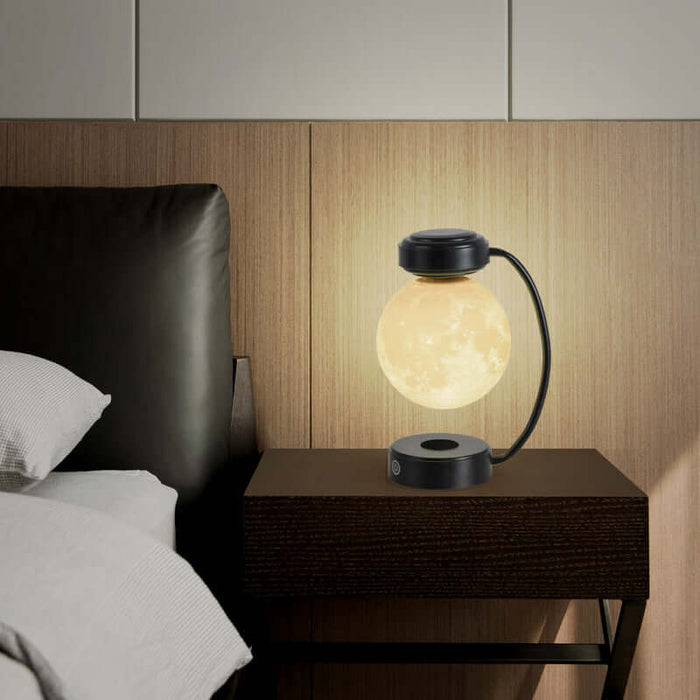 Magnetic levitating moon lamp illuminating a nightstand, showcasing its unique floating design and cozy ambiance.