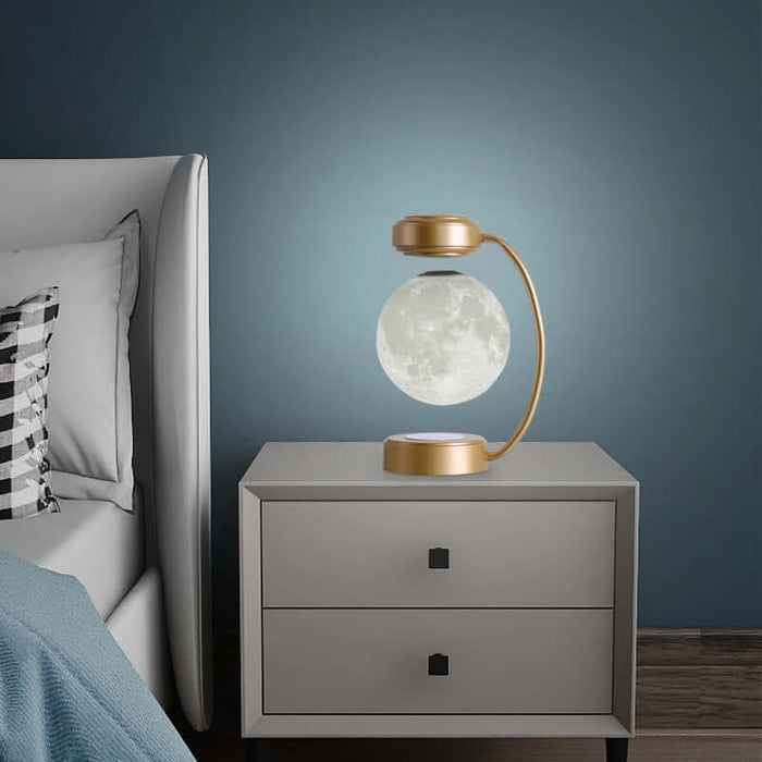 Magnetic Levitating Moon Lamp displayed on a bedside table, glowing softly in a modern bedroom setting.