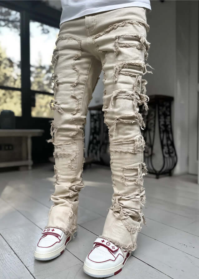 Men Ripped Stacked Slim Fit Jeans Streetwear in light color with ripped details, paired with stylish sneakers.
