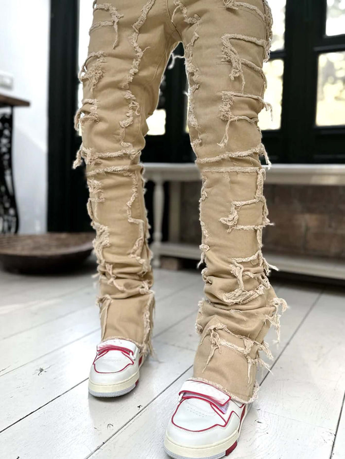 Men Ripped Stacked Slim Fit Jeans Streetwear showcased with unique ripped details and paired with stylish sneakers.