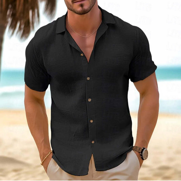 Men Short-Sleeved Button-Down Summer Shirt in black color worn by a man on the beach.