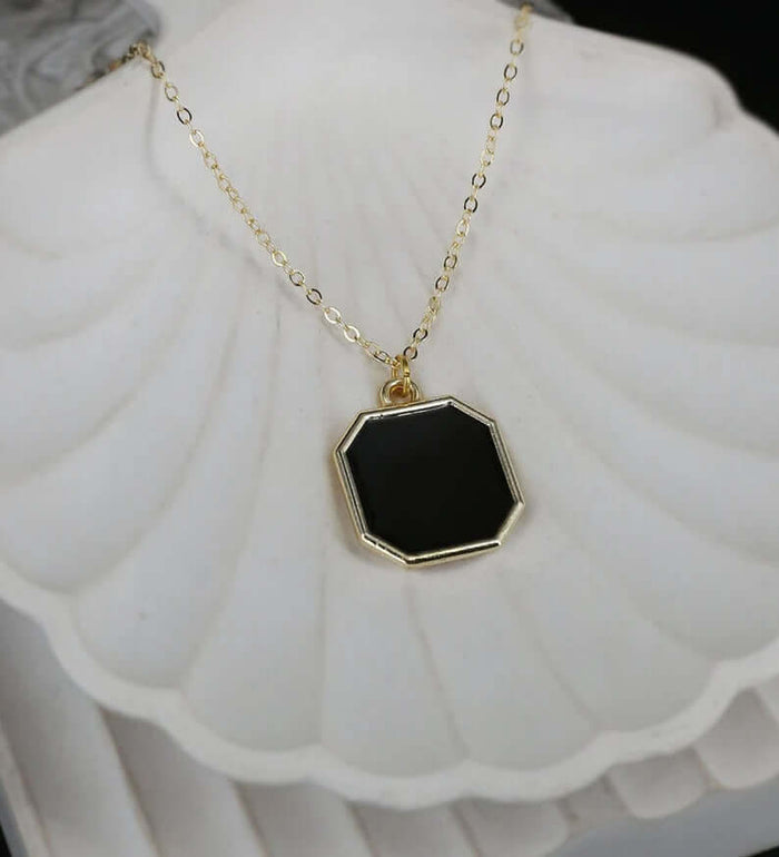 Metal Geometric Block Magic Necklace featuring a black octagonal pendant set in gold chain.