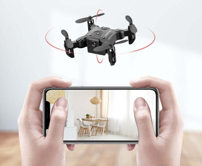 Mini Folding Drone 4K HD Aerial Photography UAV flying above a smartphone displaying interior photography.