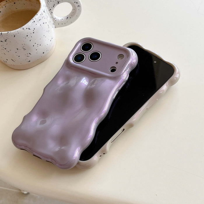 Simple Bubble Wave Pearl Drop-Proof Phone Case Cover in lavender on a table next to a coffee cup.