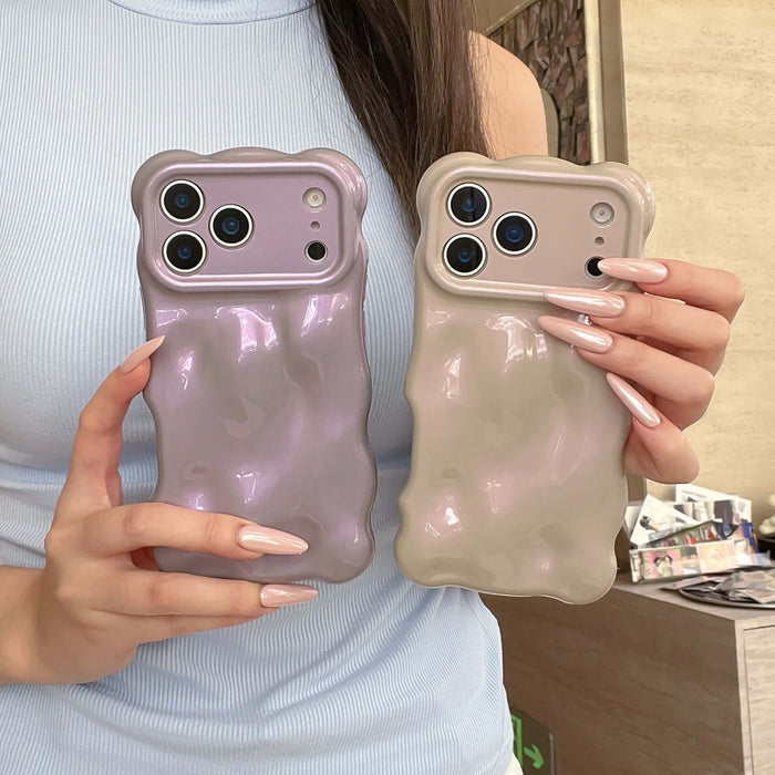 Simple Bubble Wave Pearl Drop-Proof Phone Case Cover in purple and beige held by a person showcasing unique design.
