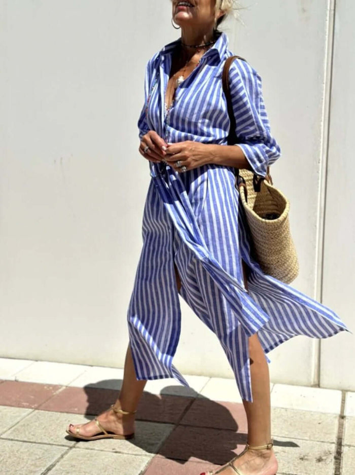 Woman wearing a Striped Half-Sleeve Belted Lapel Shirt Dress, walking outdoors with a straw bag.