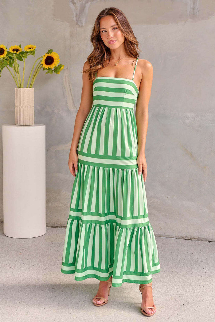 Summer Striped Suspender Long Beach Dress with Pockets worn by a model, featuring green and white stripes and a flowy design.