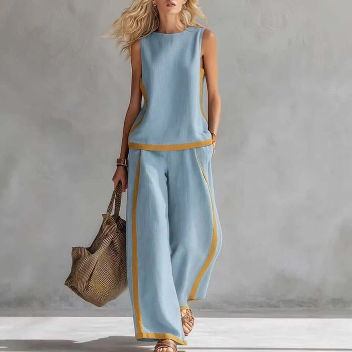 Model wearing a Summer Suits Sleeveless Vest And Wide Leg Pants Set in blue with yellow accents, carrying a stylish bag.