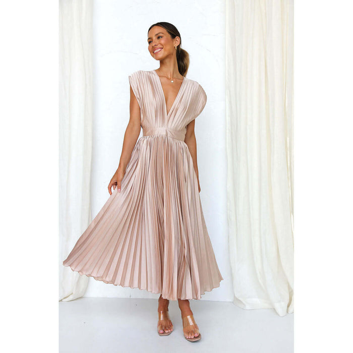 Model wearing a Summer V Neck Pleated Sleeveless Maxi Dress in beige standing gracefully.