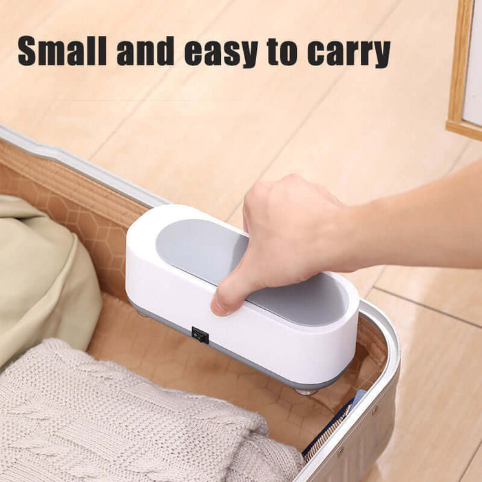 Ultrasonic High Frequency Jewelry and Glasses Cleaner being held, showcasing its small and easy-to-carry design.