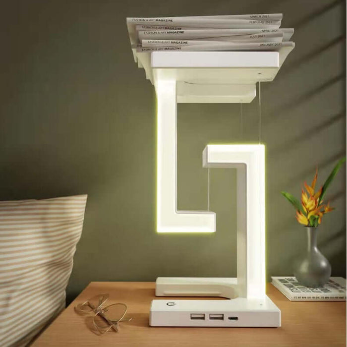 Wireless Charging Suspension Magnetic Table Lamp with modern design and space for magazines on top.