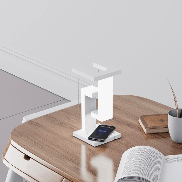 Wireless Charging Suspension Magnetic Table Lamp on a wooden table with a smartphone charging.