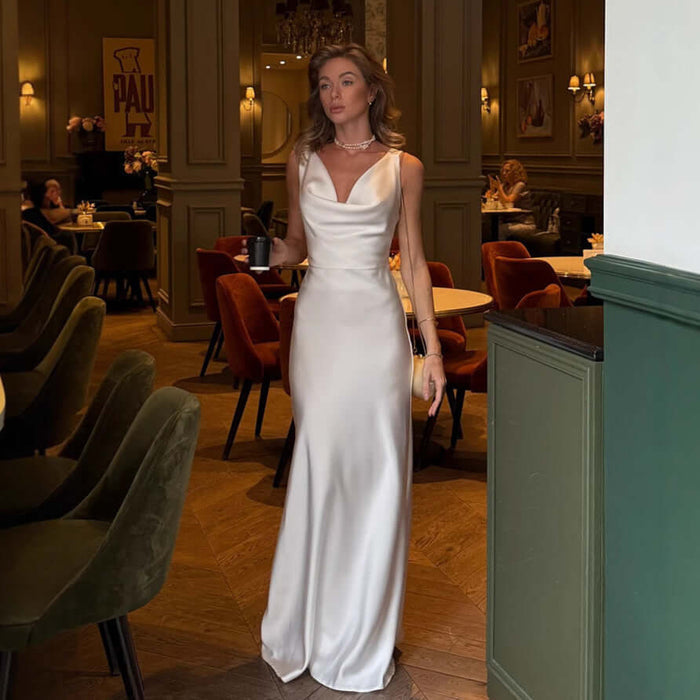 Women Fashion French Style Sleeveless V-Neck Dress in a chic restaurant setting, showcasing elegant satin design.