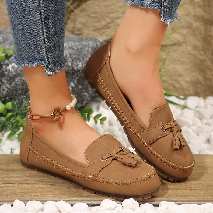 Women Round Head Loafers Non slip Soft Comfortable Flats in brown worn with jeans, showcasing stylish and comfortable design.