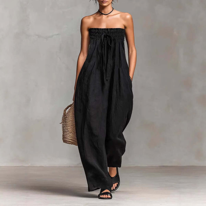 Women Strapless Ruched Jumpsuit Summer Fashion in black, featuring a loose fit and pockets, paired with sandals.