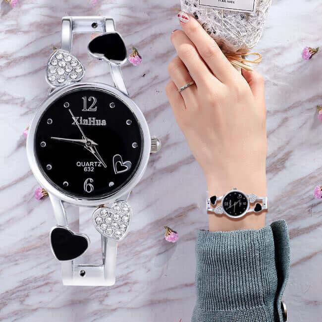 Women's British Diamond Watch featuring heart design and a stylish bracelet on a hand, perfect for elegant occasions.