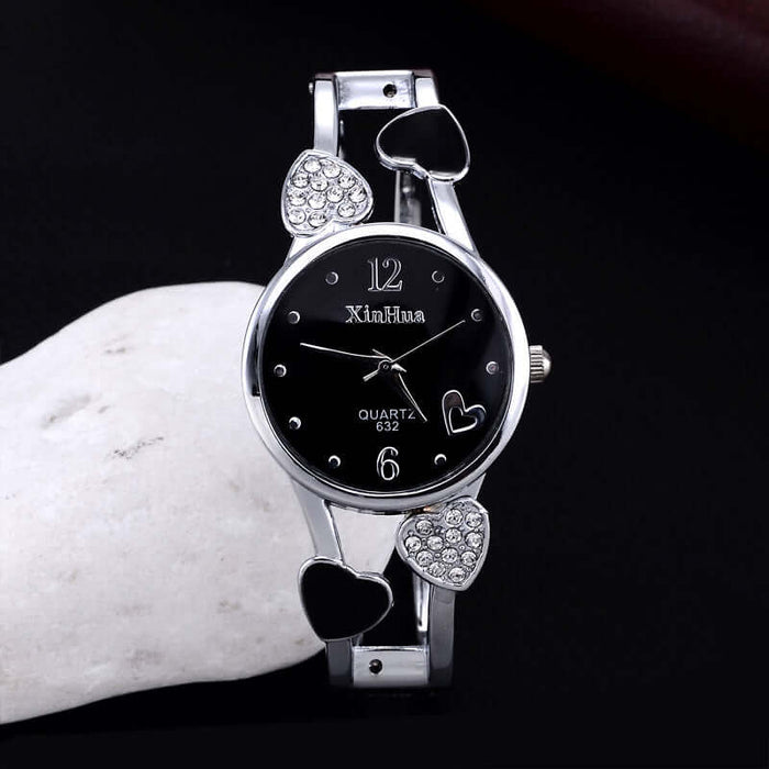 Women's British Diamond Watch featuring a sleek black dial and heart-shaped accents for a stylish look.