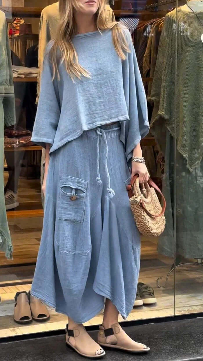 Womens Casual Loose Long Sleeve Top And Skirt Set in light blue with a relaxed fit, paired with a stylish handbag.