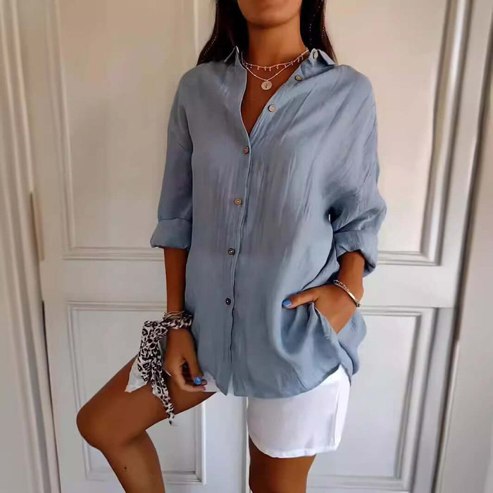 Womens Lapel Long Sleeve Single Breasted Pleated Shirt in light blue, featuring buttons and rolled sleeves, paired with shorts.